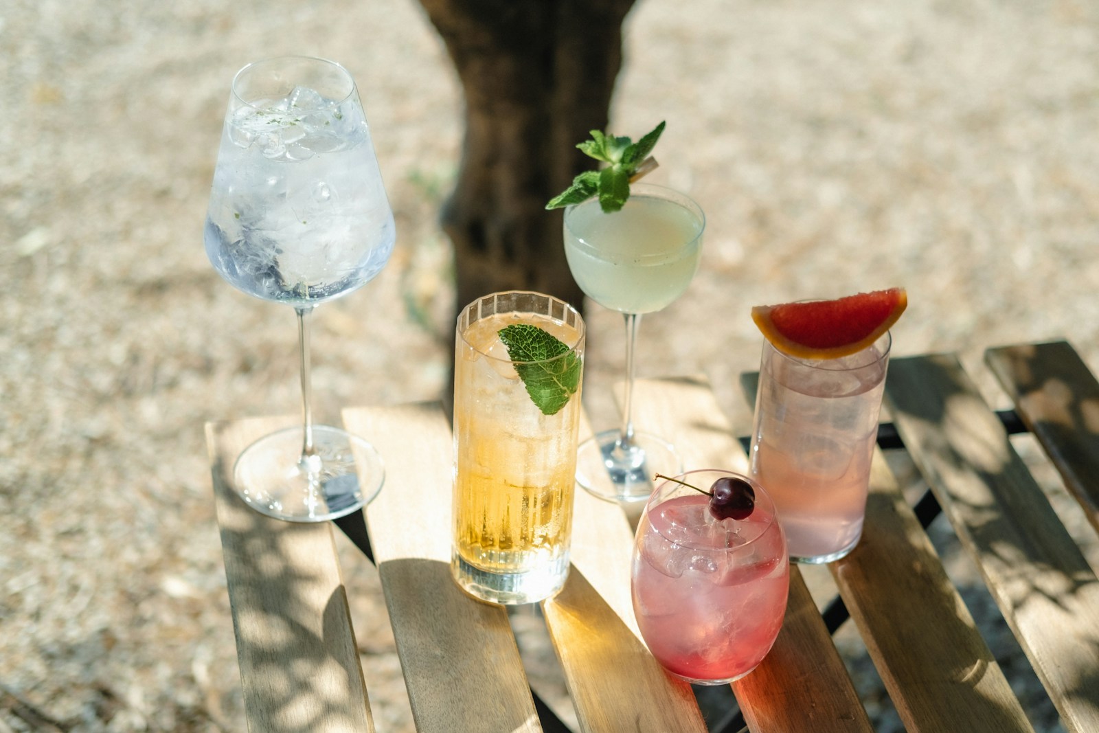 a wooden table topped with three different types of drinks